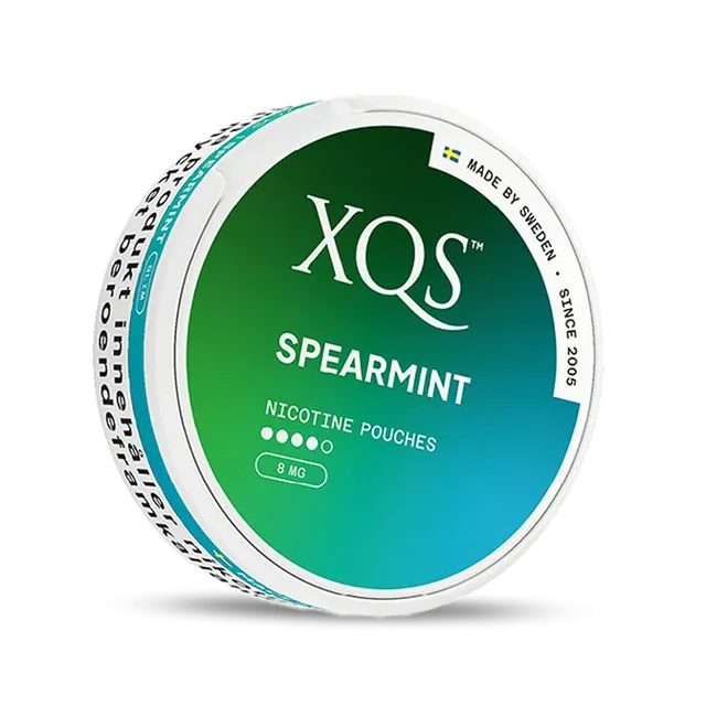 Close-up of XQS Spearmint all white nicotine pouch can. Slim format, spearmint taste, modern packaging.